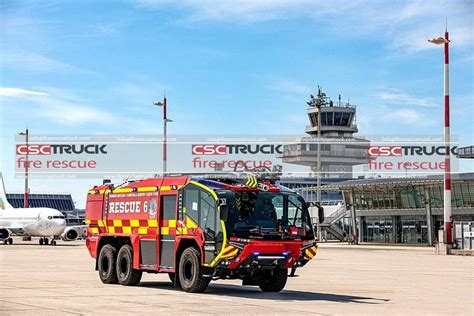 Thematic photo of an airport with a fire truck in the background, symbolizing fire safety.