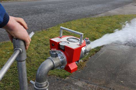 Photo of a specialist performing a fire hydrant flow test