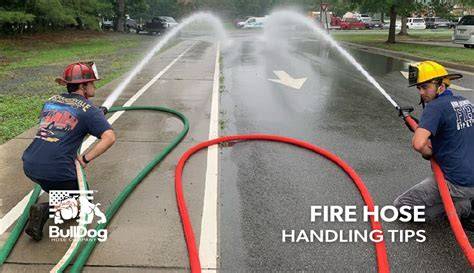 Thematic photo of firefighters handling a hose or a close-up of a fire hose with water flowing