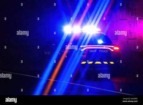 Thematic photo of police car with flashing lights or police tape