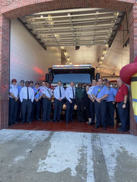 Photo from the ceremony showing the new fire truck being blessed, with firefighters, dignitaries, and community members