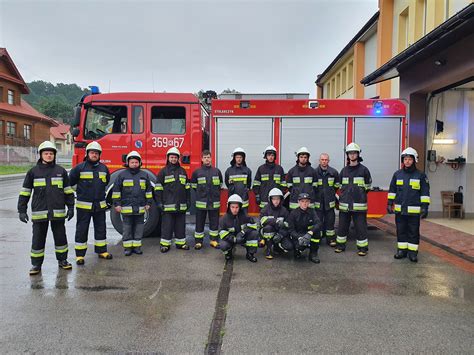 Firefighters from OSP Tuchów performing maintenance or modifications on a fire truck ladder