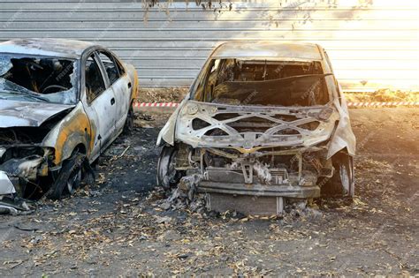 Forensic photo showing damage to cars after arson in an urban setting.