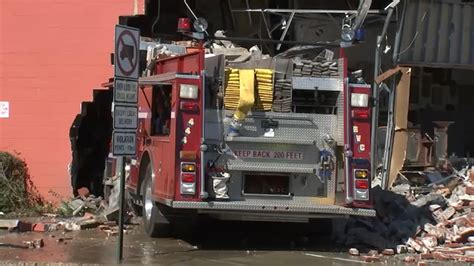 Thematic photo of a large fire truck overturned on the side of a road after an accident