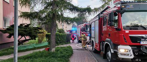Zdjęcie przedstawiające akcję gaśniczą straży pożarnej przy budynku wielorodzinnym w Łebie