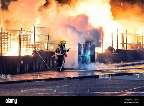 Thematic photo of firefighters extinguishing an industrial fire involving gas cylinders