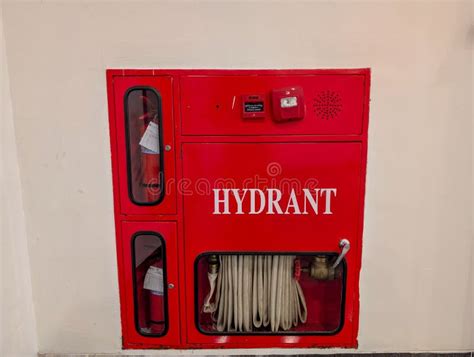 Thematic photo of a modern building interior with a clearly visible red hydrant cabinet