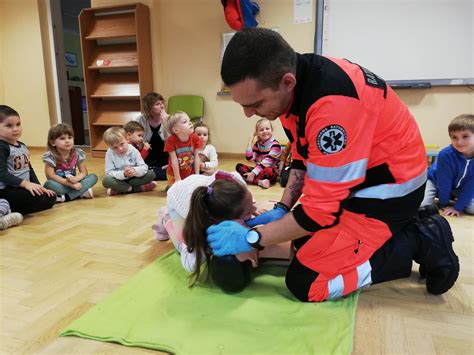 Druh OSP instruujący dzieci z pierwszej pomocy na fantomie