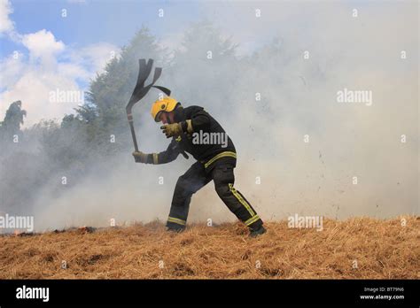 Photo of a firefighter using a fire beater (tłumica)