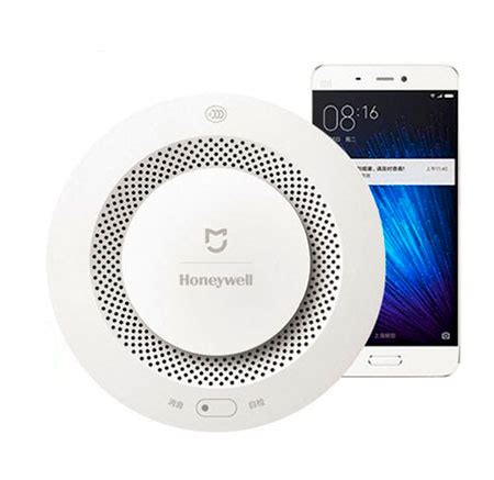 Widok z przodu i z tyłu czujnika dymu Xiaomi Mijia Honeywell, z widocznymi wlotami powietrza i miejscem na baterię