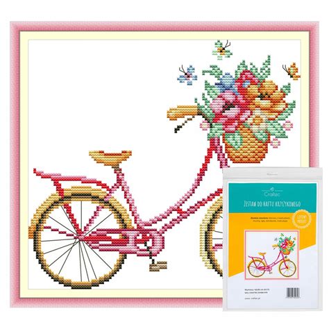 Przykładowe zdjęcie zestawu do haftu krzyżykowego, ukazujące jego zawartość: kanwę, mulinę, igłę i wzór.