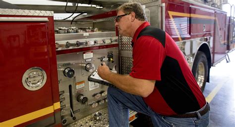 Photo of an OSP driver inspecting a fire truck