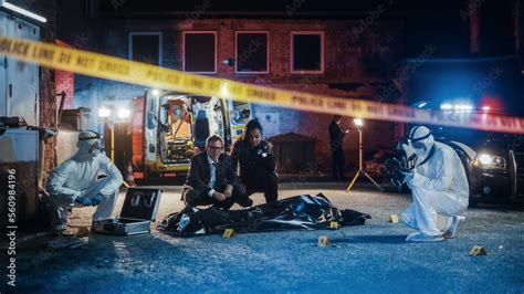 Photo of police and forensic investigators at the scene of the fire