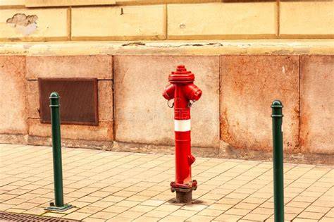 Thematic photo of a fire hydrant on a street, possibly with a building in the background that resembles ul. Płochocińska 15a if possible