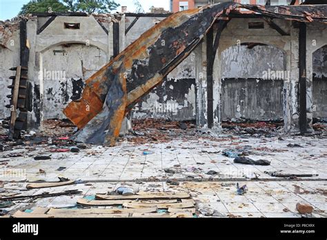 Photo showing the collapsed roof structure of a building after a fire