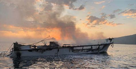 The Conception dive boat engulfed in flames, with rescue boats approaching