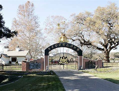 Thematic photo of Neverland Ranch main gate with smoke in the background