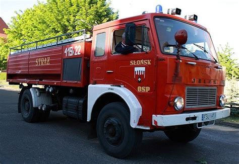The current 40-year-old Jelcz fire truck of OSP Chorzęcin standing in front of the renovated fire station.