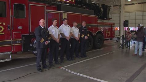 Thematic photo of a new fire truck with firefighters and officials.