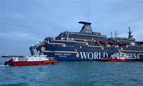 The World Legacy cruise ship on fire during its voyage to Singapore, with smoke visible from the salon area.
