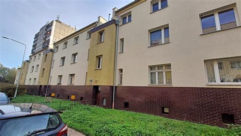 płonące mieszkanie na parterze bloku, widoczne okopcenie elewacji