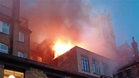 Thematic photo of hotel fire at night with visible flames on the roof
