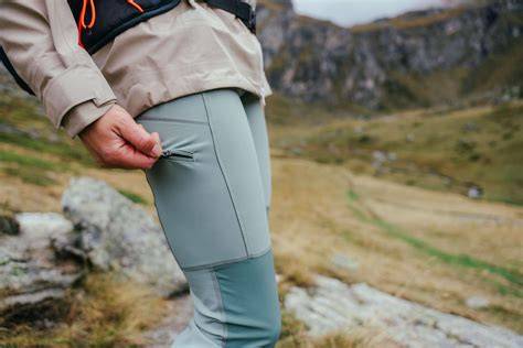 Thematic photo of a person hiking in Mammut pants in a scenic mountain landscape
