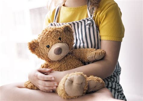 Thematic photo showing a child holding a plush toy and an emergency service worker in the background