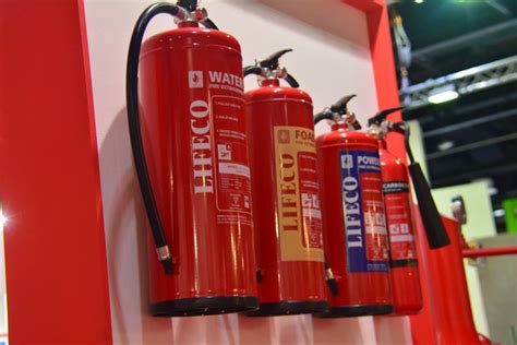 Thematic photo of various fire extinguishers and a fire blanket in a commercial or industrial setting.