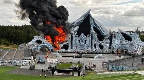 The main stage of Tomorrowland festival engulfed in flames, thick smoke visible
