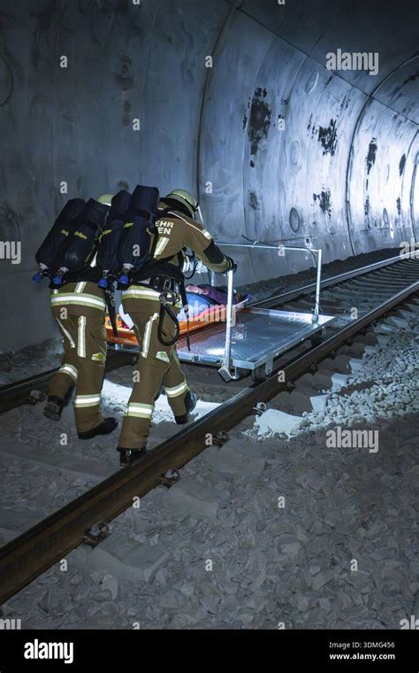 Thematic photo of firefighters laying a hose across railway tracks