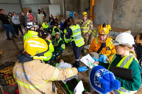 Photo of a firefighter making quick notes on a glove during a simulated rescue operation