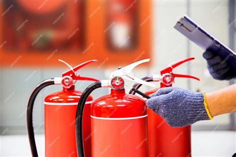 Photo of a firefighter conducting a fire safety inspection in a public building, checking an exit sign or fire extinguisher