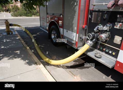 Thematic photo of a fire hydrant on a street with a fire truck in the background