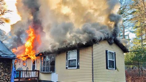 Photo of a residential building fire with visible smoke