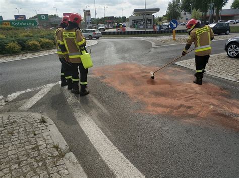 Zdjęcie strażaków neutralizujących plamę oleju na drodze