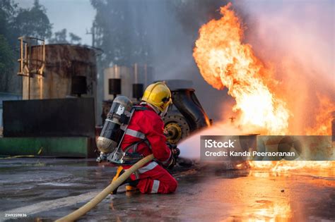 Photo of firefighters extinguishing a blaze with water hoses