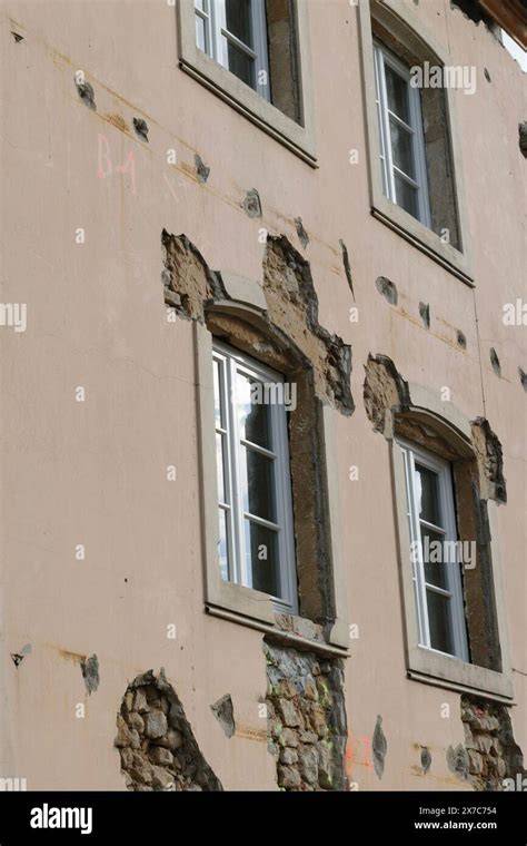 Photo of firefighters and a school building with visible damage to the facade