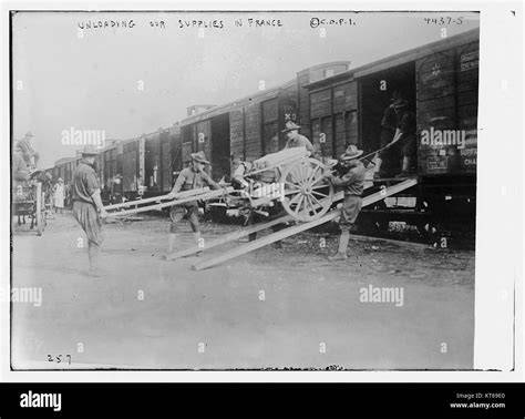 Historical photo of fire engines being unloaded or assembled in a post-war setting