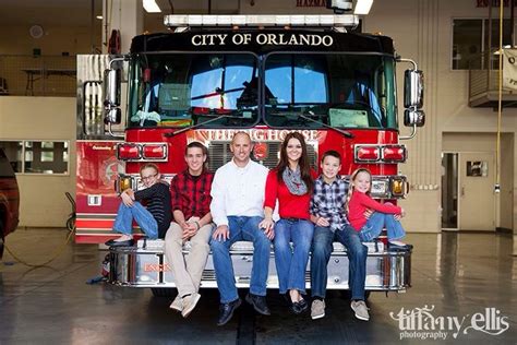 Photo of a multi-generational firefighter family, perhaps in front of a fire station