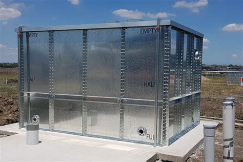 Photo of a large steel panel fire fighting tank during installation