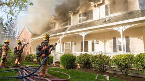Thematic photo of a large house fire with firefighters working