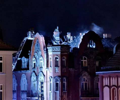 Zdjęcie przedstawiające pożar na dachu zabytkowej kamienicy
