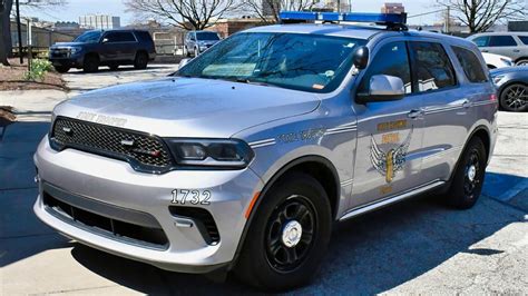 Photo of OSP vehicles with lights on during a tribute