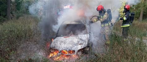 Zdjęcie płonącego samochodu osobowego na poboczu drogi
