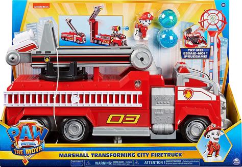 The Paw Patrol Marshall Deluxe Fire Truck toy with Marshall figure, showing its various features like the ladder and water projectiles.