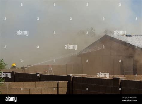 Thematic photo of a wooden house fire in a rural area, with firefighters on site
