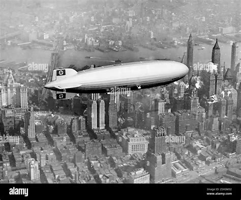 The Hindenburg airship flying over a city skyline