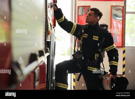 Thematic photo of a fire station with a visible firefighter slide or door leading to it.