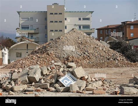 Photo of a collapsed construction site, showing debris and emergency personnel at work.